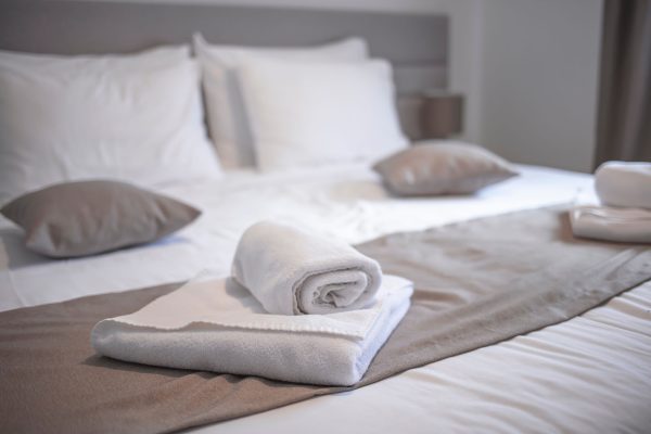 Clean,Towels,On,Bed,At,Hotel,Room.,Bed,Maid-up,With Clean towels on bed at hotel room. Bed maid-up with clean white pillows and bed sheets in beauty bedroom. Close-up. interior background. Towel in Hotel Room , Welcome guests , Room service